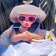 Ruby joined the competition — help win amazing prizes! baby, sunglasses, pacifier, hat, blanket, stroller, child, sunlight, outdoor, pink, clothing, cute, infant, hands, seatbelt, shade, relaxing, portrait, summer, accessory