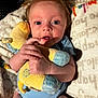 Ruby is registered to the contest to win money with this photo: baby, infant, stuffed_animal, toy, blue_onesie, blanket, lying_down, hand, face, eyes, expression, cute, soft_toy, comfort, child, portrait, indoors, cozy, skin, hair