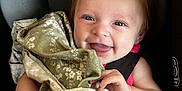 Ruby joined the competition — help win amazing prizes! baby, smiling, car_seat, blanket, happy, infant, child, person, hair, clothing, seatbelt, cute, face, portrait, indoor, comfort, hand, skin, expression, closeup