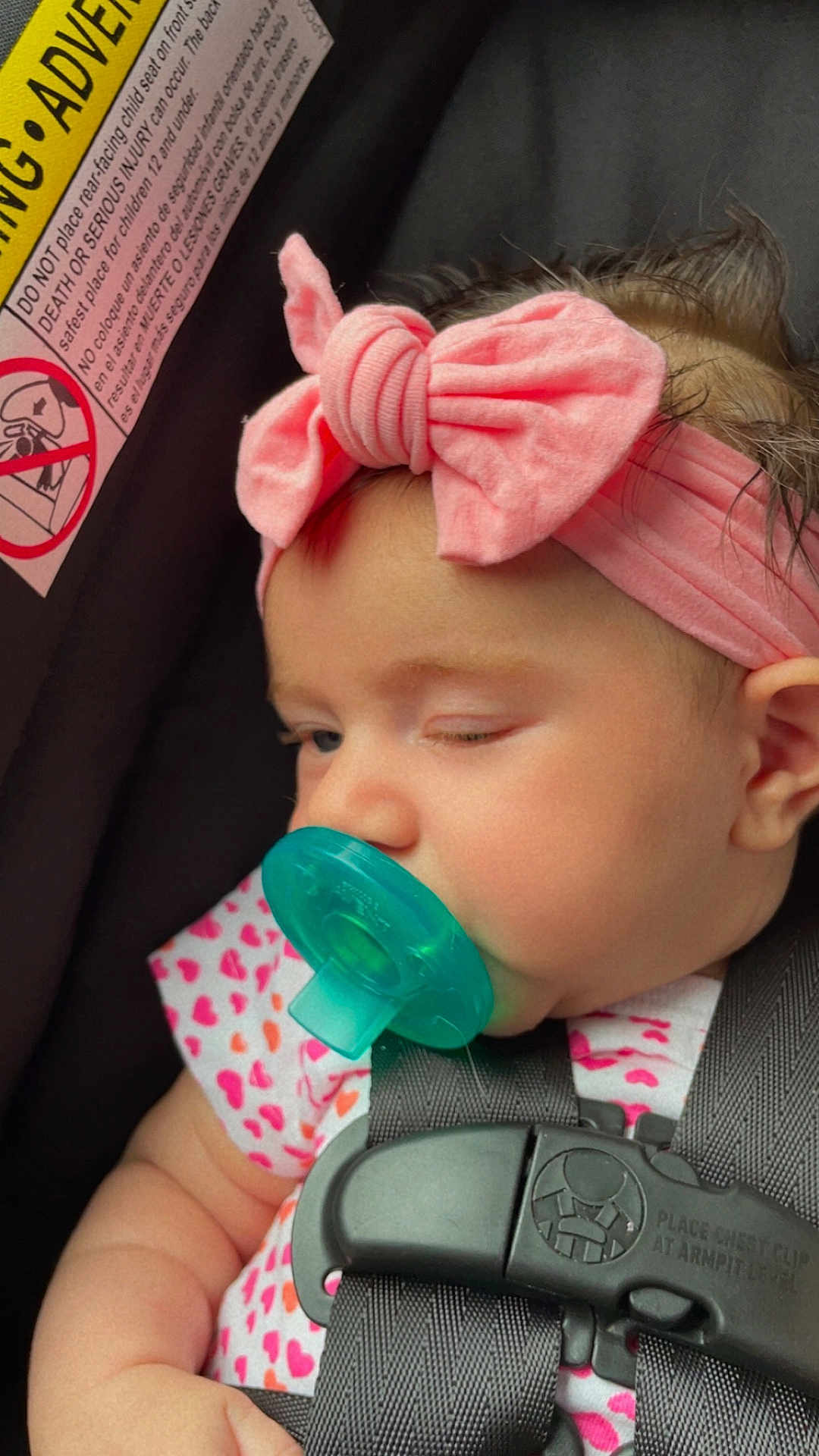 Violet joined the competition — help win amazing prizes! baby, pacifier, car_seat, headband, pink_bow, child, sleepy, infant, cute, straps, clothing, face, closeup, seatbelt, adorable, young_child, heart_pattern, skin, hair, comfort