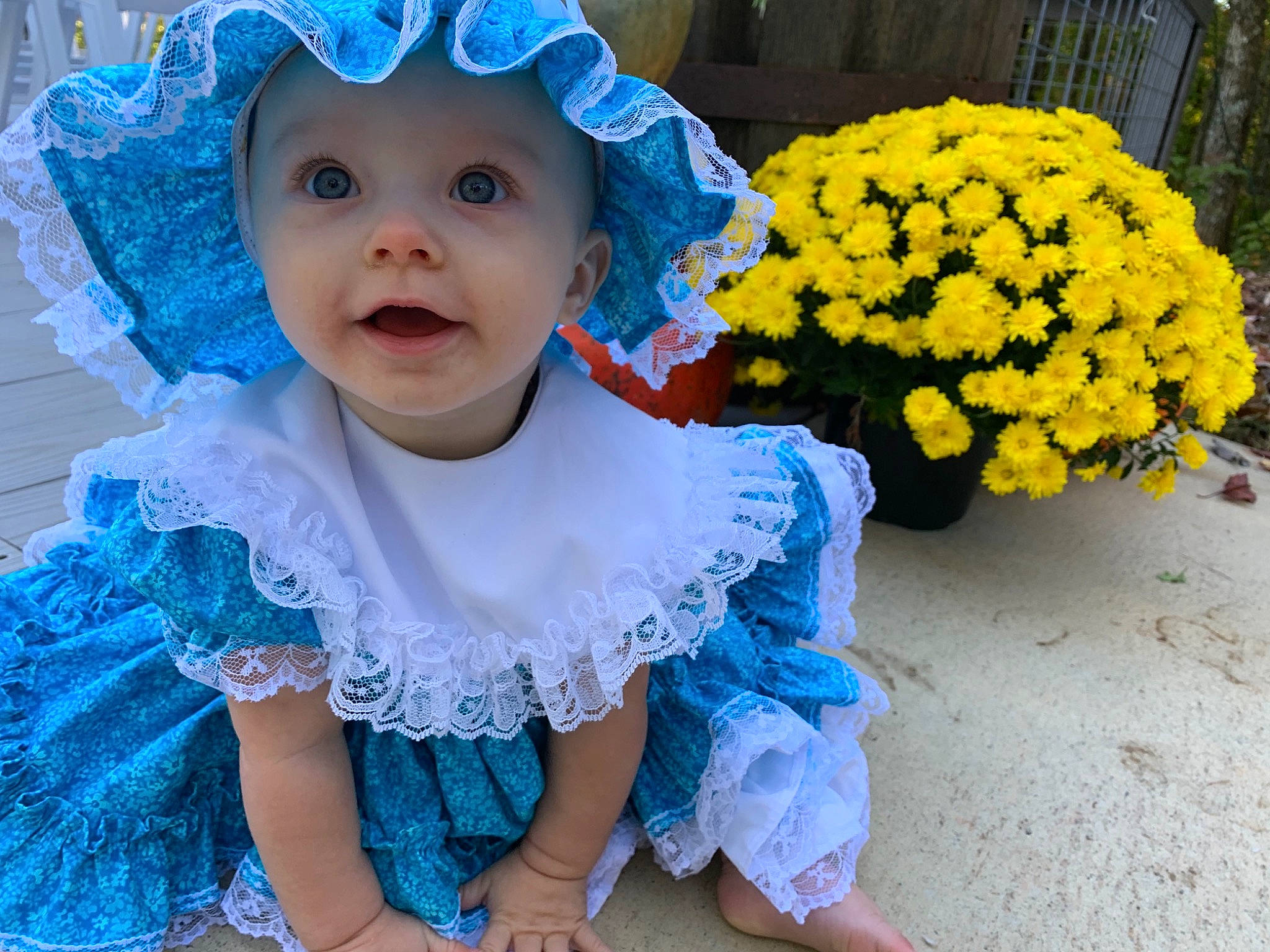 Jolene is registered to the contest to win money with this photo: baby, baby_toddler_clothing, blue, cap, costume_hat, dress, flower, flowerpot, grass, happy, headwear, iris, people, person, petal, photograph, pink, plant, purple, smile