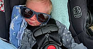 Dakota joined the competition — help win amazing prizes! baby, car_seat, sunglasses, blanket, infant, clothing, straps, seatbelt, star_pattern, cute, sleeping, child, indoors, comfort, headwear, resting, closeup, infant_clothing, baby_accessory, soft_toys
