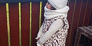 Mila participe au concours pour gagner de l'argent avec cette photo : black_shoes, child, clouds, coat, deck, fence, footwear, girl, greenery, hat, leopard_print, mountain, nature, outdoor, profile, scarf, sky, standing, winter_clothing, wood