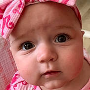 Briella joined the competition — help win amazing prizes! baby, infant, child, pink, headband, bow, clothing, face, eyes, indoors, portrait, cute, expression, patterned_clothing, toddler, human, person, young_child, closeup, curious