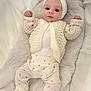 Gracie joined the competition — help win amazing prizes! baby, infant, knitwear, headband, bow, blue_eyes, quilted, blanket, cozy, cute, lying_down, white_clothing, patterned_pants, soft_texture, child, newborn, portrait, indoors, hands_up, comfortable