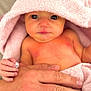 baby, infant, towel, pink, hooded_towel, hand, adult, tattoo, skin, naked_torso, cute, expression, holding, closeup, person, portrait, newborn, child, soft_texture, indoor