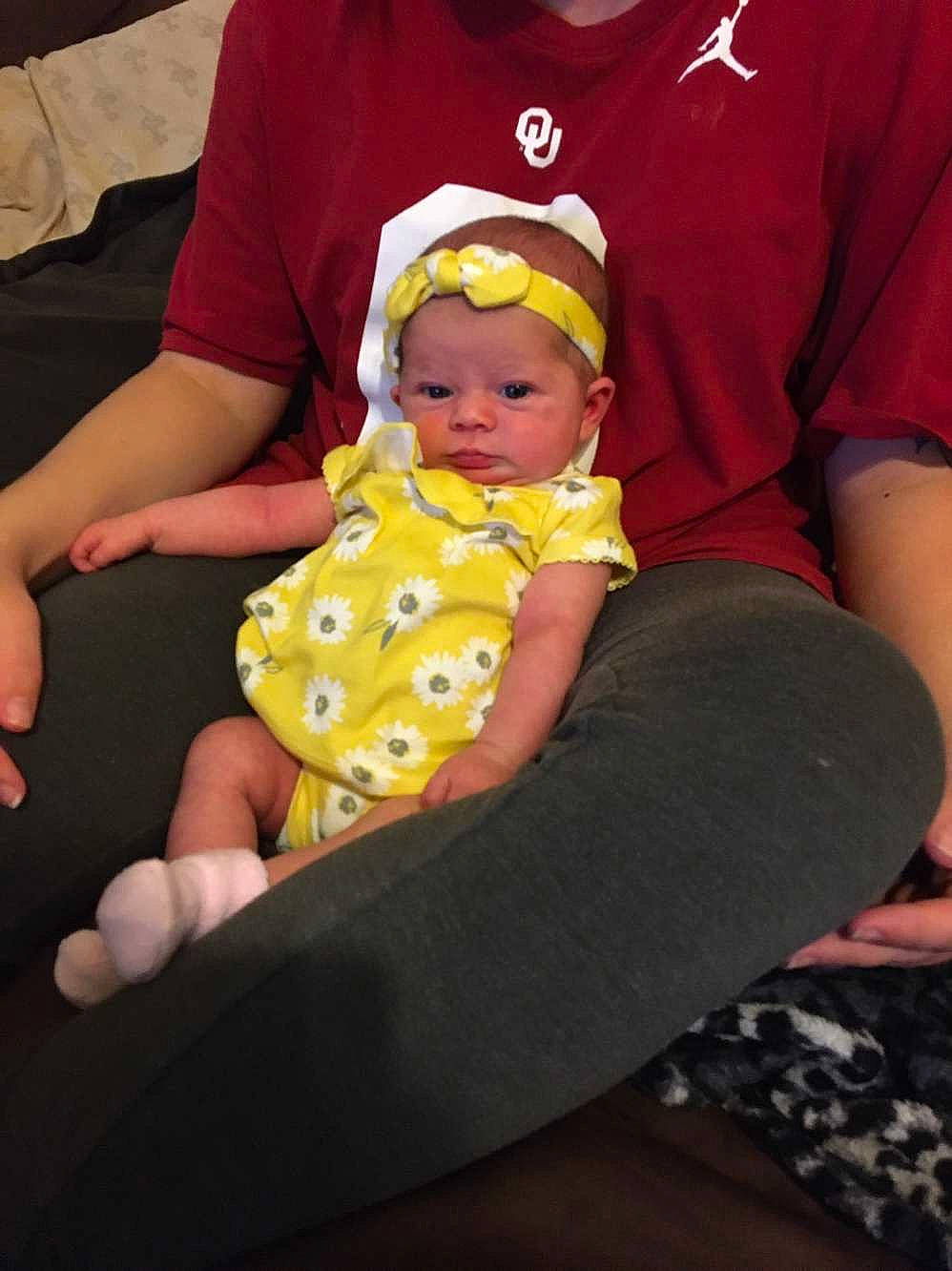 Brixley is registered to the contest to win money with this photo: baby, baby_toddler_clothing, cheek, comfort, eye, face, facial_expression, fun, happy, head, human_body, lap, mouth, pattern, person, skin, sleeve, t_shirt, thigh, toddler