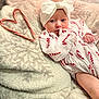 Carson is registered to the contest to win money with this photo: baby, infant, candy_cane, heart_shape, blanket, headband, white_bow, cozy, cute, holiday, christmas, patterned_clothing, red_and_white, soft_texture, newborn, lying_down, portrait, child, festive, holiday_season