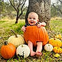 Hayes is registered to the contest to win money with this photo: baby, pumpkin, autumn, outdoor, tree, grass, smile, child, nature, fall, cute, seasonal, orange, white_pumpkin, yellow_pumpkin, black_cat_pumpkin, feet, happy, holiday, portrait