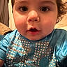 baby, blue_shirt, casual_clothing, cheeks, child, close_up, curly_hair, cute, expression, eyes, face, indoor, looking_at_camera, mouth, person, portrait, skin, soft_lighting, toddler, young_child