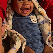 Marcel joined the competition — help win amazing prizes! baby, smiling, hooded_blanket, blue_outfit, crocodile_patch, happy, infant, child, cozy, warm_clothing, cute, portrait, indoor, person, skin, face, expression, comfort, joy, sitting