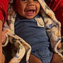baby, smiling, hooded_blanket, blue_outfit, crocodile_patch, happy, infant, child, cozy, warm_clothing, cute, portrait, indoor, person, skin, face, expression, comfort, joy, sitting