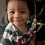 Marcel is registered to the contest to win money with this photo: toddler, child, smiling, curly_hair, striped_shirt, lee, indoor, portrait, happy, person, baby, clothing, hand, face, sitting, closeup, cute, young_child, casual, warm_lighting