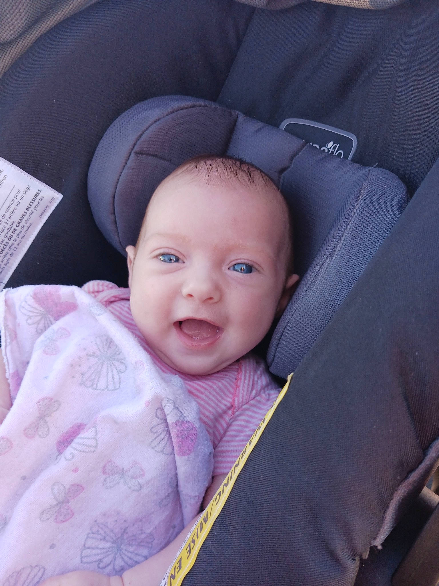 Valerie is registered to the contest to win money with this photo: baby, baby_products, baby_toddler_clothing, car_seat, cheek, child, comfort, electric_blue, eyebrow, happy, iris, linens, magenta, person, product, seat_belt, skin, sleeve, smile, textile