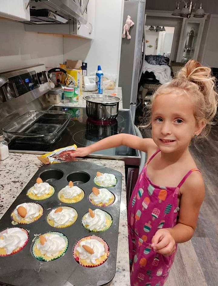 Averie is registered to the contest to win money with this photo: baking, comfort_food, cook, cooking, countertop, cuisine, delicacy, dish, finger_food, food, ingredient, joy, kitchen, kitchen_appliance, person, plate, recipe, service, smile, t_shirt