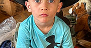 Michael is registered to the contest to win money with this photo: accessories, boy, chair, child, clothing, cowboyhat, face, footwear, furniture, hat, head, male, pants, person, photography, portrait, shoe, sleeve, sunhat, t_shirt