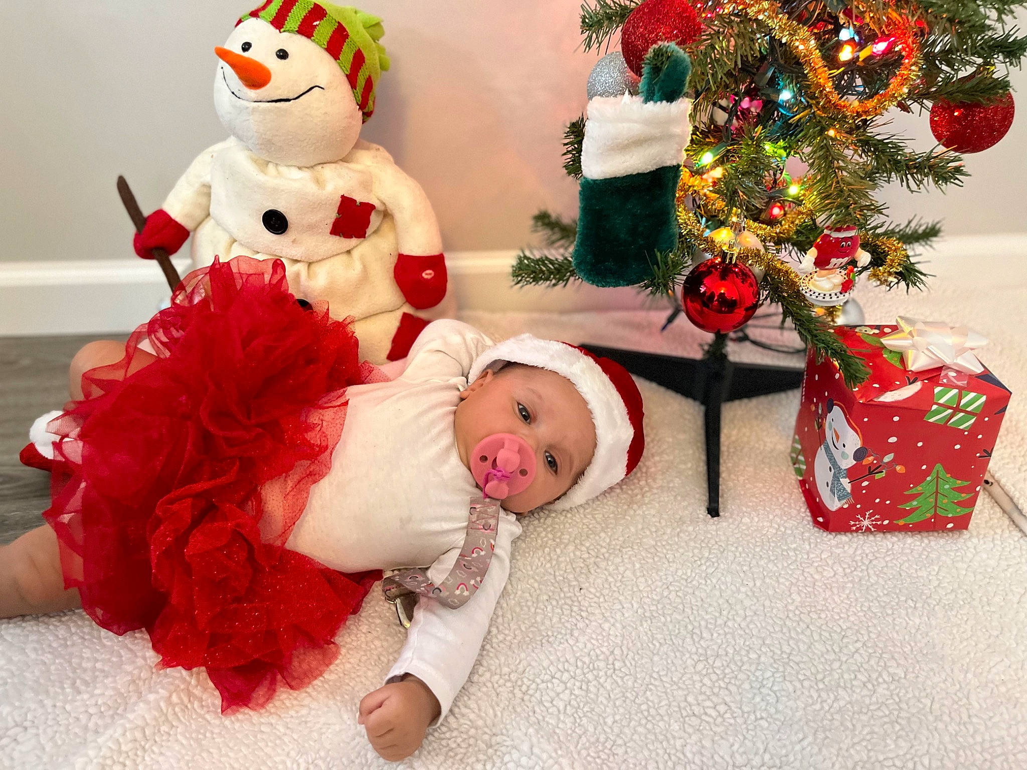Asia joined the competition — help win amazing prizes! baby, baby_toddler_clothing, carmine, child, christmas, christmas_decoration, christmas_ornament, christmas_tree, costume_hat, event, happy, hat, headwear, holiday, mammal, ornament, person, red, santa_claus, snowman