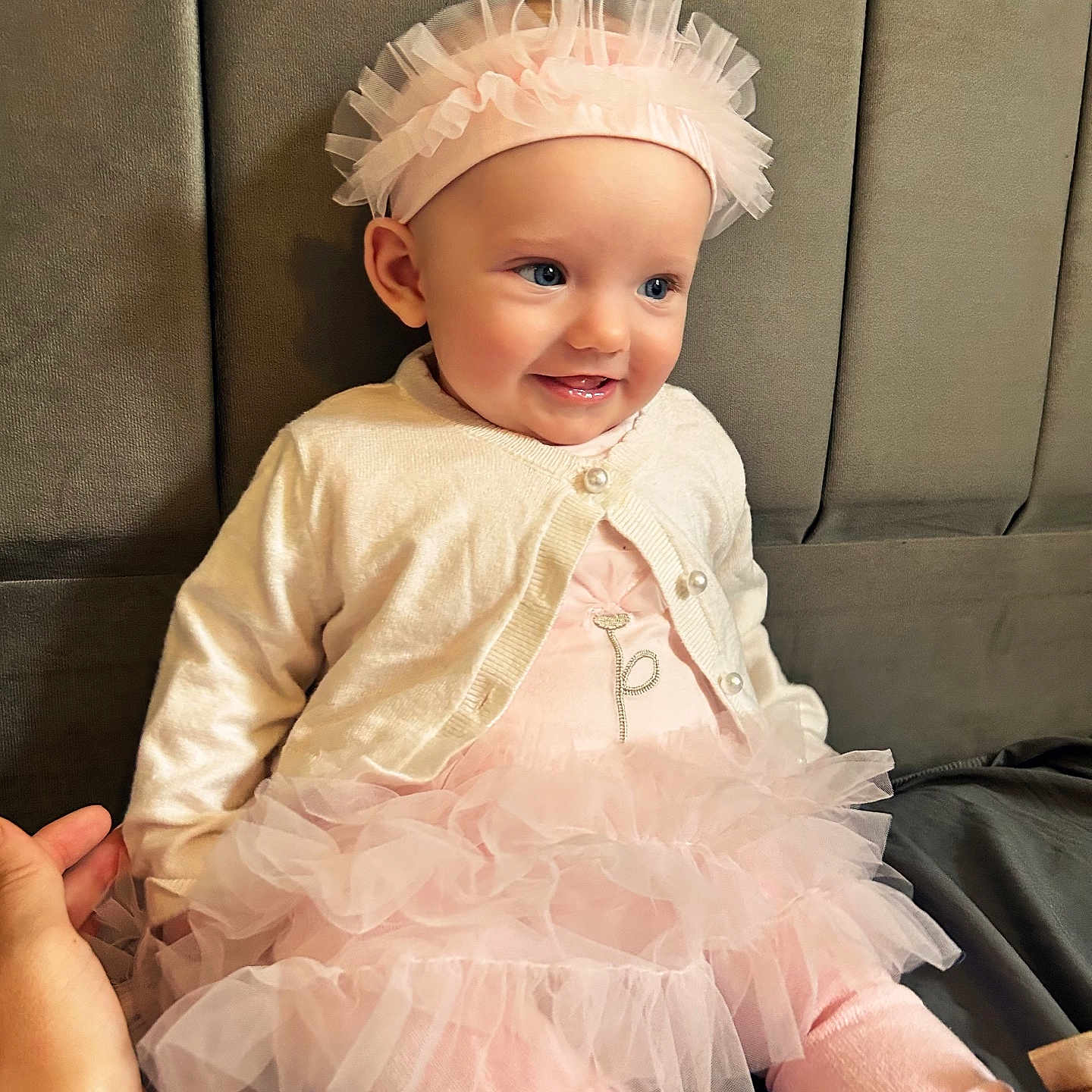 Margaux is registered to the contest to win money with this photo: baby, cardigan, child, clothing, cushion, cute, footwear, girl, hand, happy, headband, indoor, person, pink, portrait, sitting, smile, soft, tutu, young