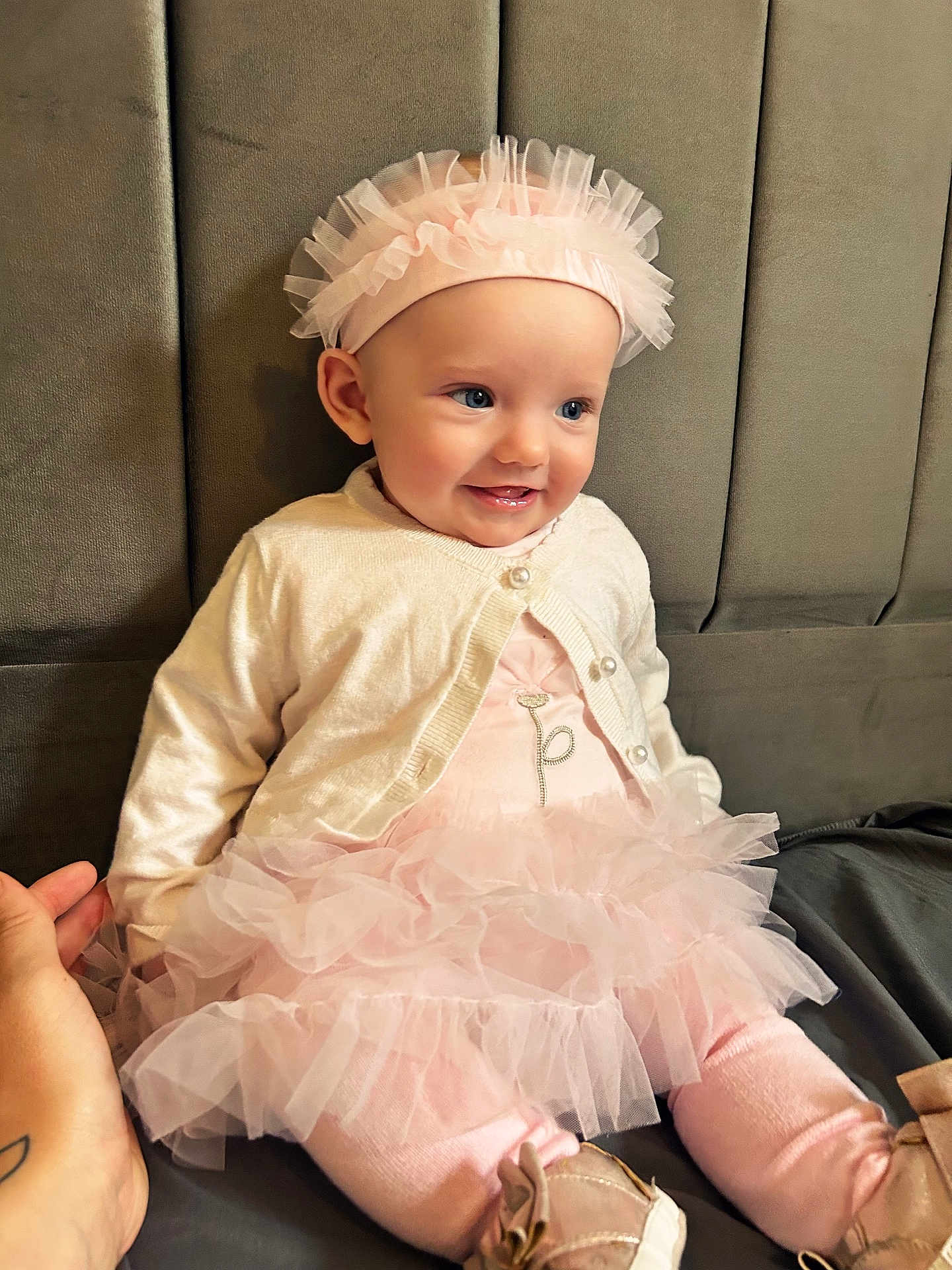 Margaux is registered to the contest to win money with this photo: baby, child, girl, tutu, headband, pink, smile, sitting, cushion, cardigan, clothing, footwear, happy, portrait, indoor, person, cute, hand, soft, young