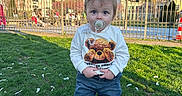Liam Creciun participe au concours pour gagner de l'argent avec cette photo : toddler, child, pacifier, grass, jeans, sneakers, sweatshirt, teddy_bear, outdoor, daylight, fence, park, people, blue_sky, trees, buildings, casual_clothing, cute, standing, sunny