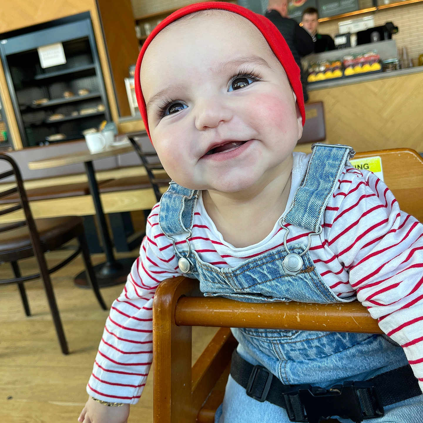 Arda is registered to the contest to win money with this photo: adult, baby, baseballcap, cap, chair, clothing, cup, face, furniture, hat, head, jeans, male, man, pants, person, photography, plywood, portrait, wood