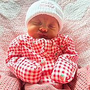 Margot Lynda Stirk joined the competition — help win amazing prizes! baby, newborn, sleeping, blanket, pink, hat, clothing, pattern, strawberry, cozy, cute, infant, portrait, soft, warm, face, headwear, bed, rest, peaceful