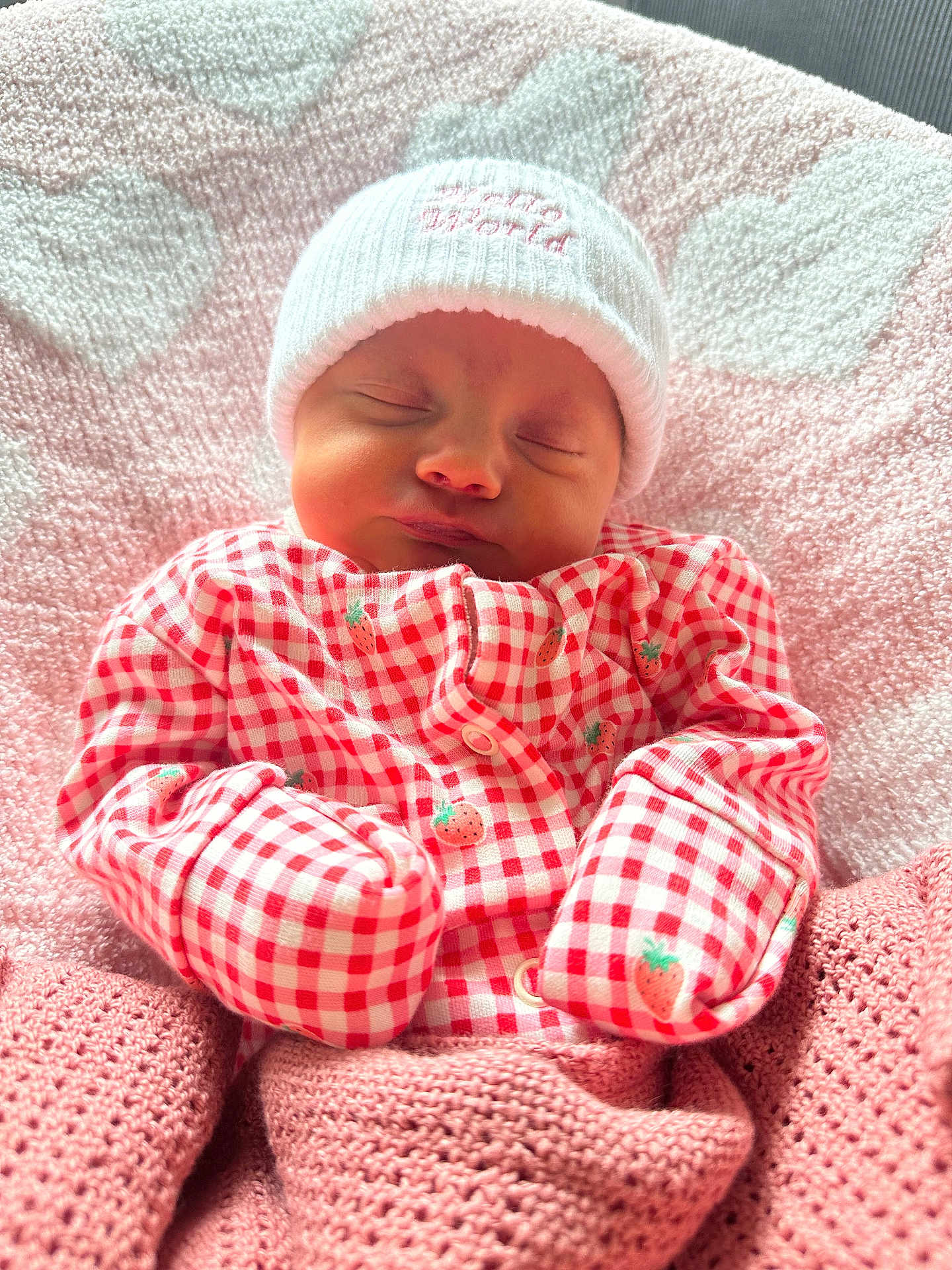 Margot Lynda Stirk joined the competition — help win amazing prizes! baby, newborn, sleeping, blanket, pink, hat, clothing, pattern, strawberry, cozy, cute, infant, portrait, soft, warm, face, headwear, bed, rest, peaceful