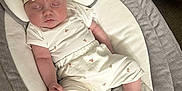 Margot Lynda Stirk joined the competition — help win amazing prizes! baby, infant, sleeping, headband, bow, cushioned_lounger, white_outfit, fruit_print, cozy, comfortable, couch, fabric, soft_lighting, peaceful, child, person, indoor, relaxing, cute, newborn