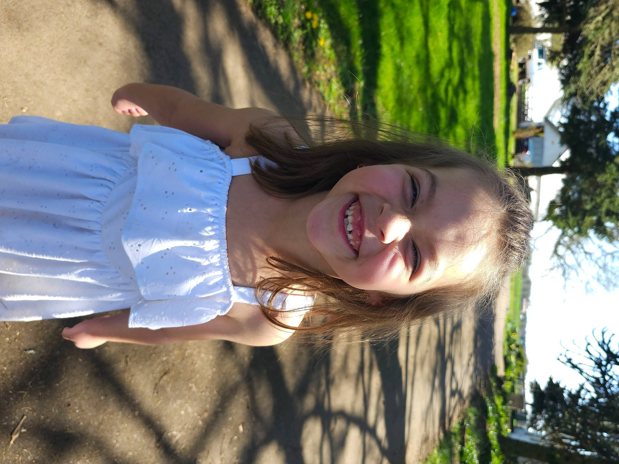 Rosalie is registered to the contest to win money with this photo: black_hair, botany, brown_hair, child, electric_blue, fun, grass, happy, human_leg, joy, leisure, long_hair, people_in_nature, person, plant, recreation, smile, sunlight, tints_and_shades, tree