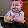 baby, child, infant, headband, pink, purple_shirt, blue_eyes, smile, hands, clapping, high_chair, indoor, wooden_furniture, face, cute, happy, seated, person, young_child, baby_seat