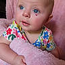 Alice is registered to the contest to win money with this photo: baby, blue_eyes, floral_shirt, pink_blanket, curious, infant, soft_texture, closeup, child, cute, indoor, portrait, plush, hand, face, skin, person, young_child, colorful_clothing, toddler