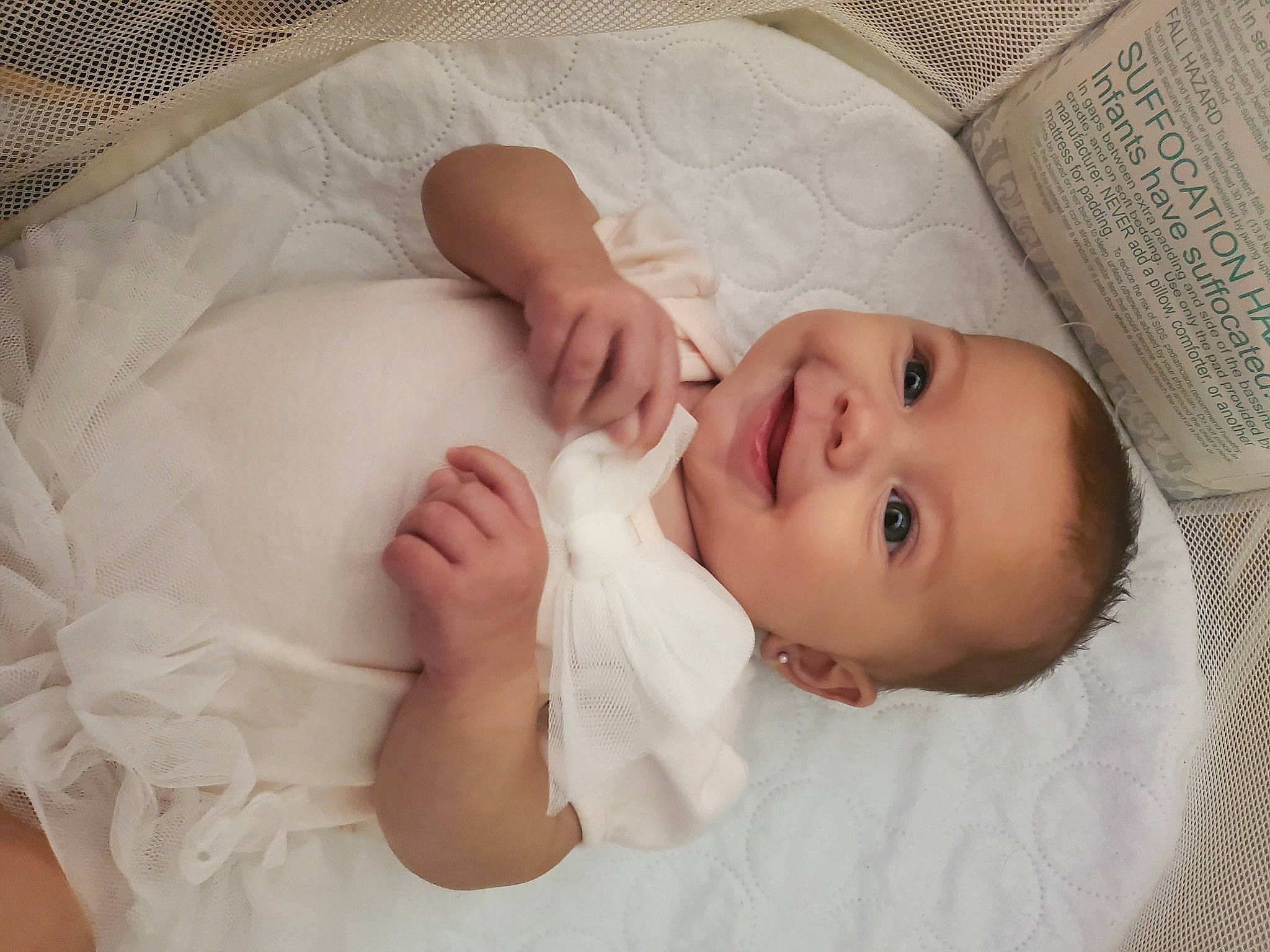 Madelyn is registered to the contest to win money with this photo: baby, baby_toddler_clothing, cheek, child, comfort, eye, eyebrow, facial_expression, finger, gesture, headgear, iris, joy, lip, mammal, nose, person, skin, sleeve, smile