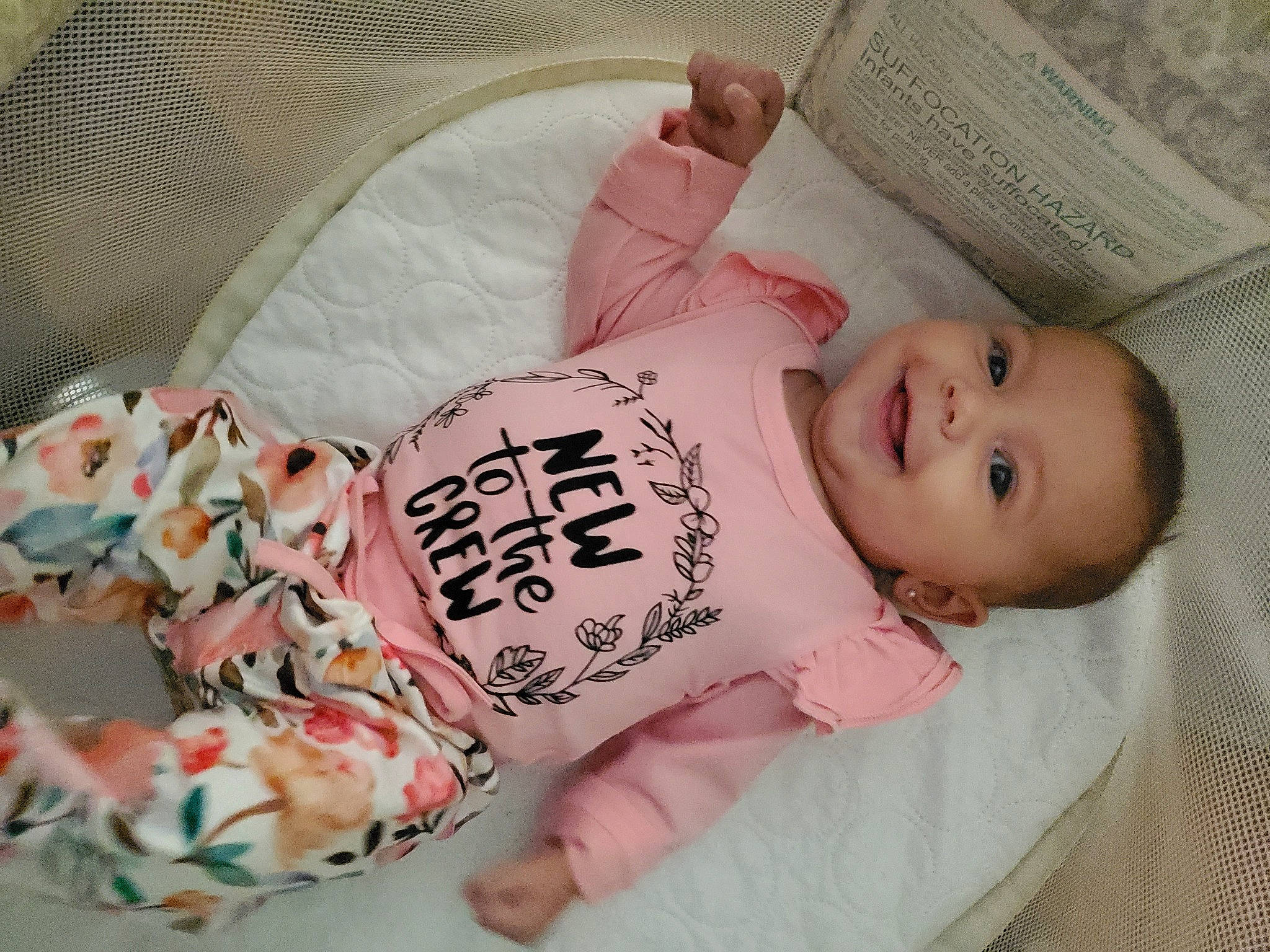 Madelyn is registered to the contest to win money with this photo: arm, baby, baby_toddler_clothing, cheek, child, chin, comfort, dress, finger, headgear, human_body, joy, mammal, nose, person, pink, product, skin, sleeve, smile