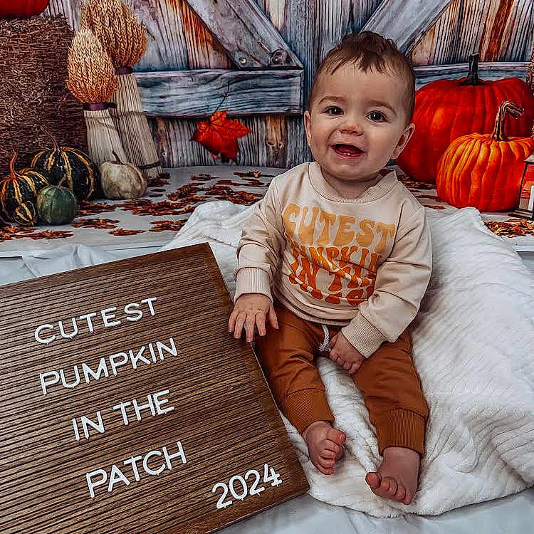 Thomas is registered to the contest to win money with this photo: baby, babylaughing, clothing, face, happy, head, people, person, photography, portrait, quilt, sitting, sleeve, smile