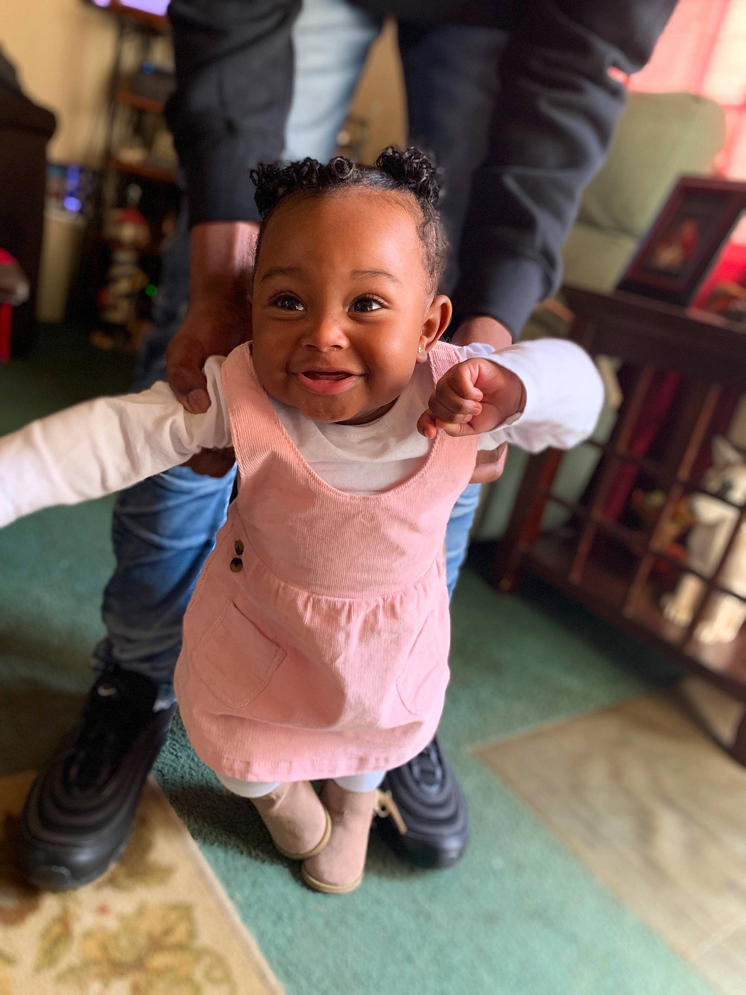 Zaniyah is registered to the contest to win money with this photo: arm, baby, cheek, child, face, facial_expression, finger, footwear, fun, hand, happy, head, joint, leg, people, person, pink, skin, smile, standing