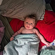 Lukah joined the competition — help win amazing prizes! baby, child, towel, bed, pillow, blanket, smile, face, hair, skin, arm, indoors, cozy, lying_down, comfort, cute, expression, resting, soft, warm