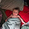 baby, child, towel, bed, pillow, blanket, smile, face, hair, skin, arm, indoors, cozy, lying_down, comfort, cute, expression, resting, soft, warm