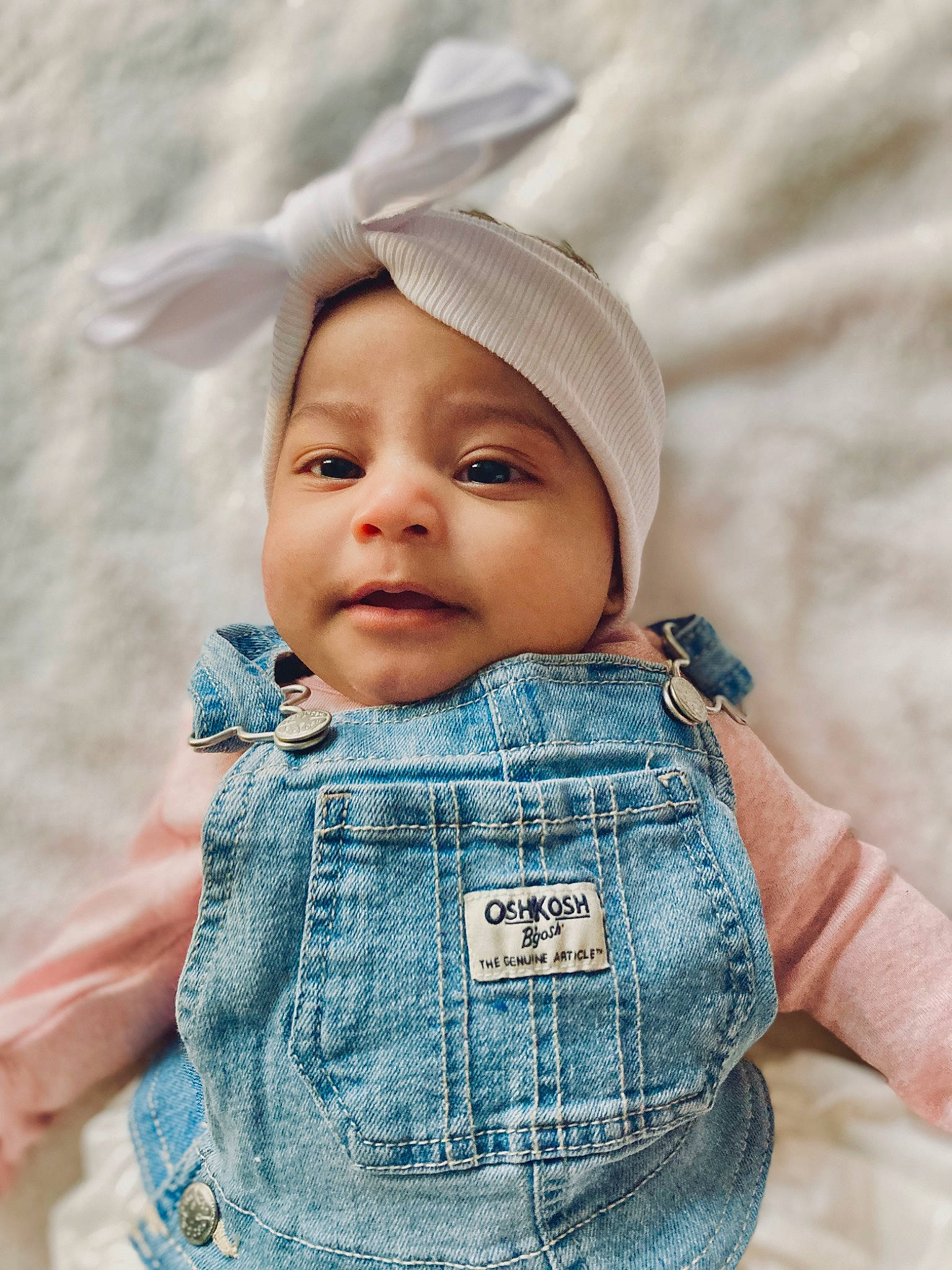 Raelynn is registered to the contest to win money with this photo: azure, baby, baby_toddler_clothing, cap, cheek, chin, eye, face, happy, headwear, iris, lip, organ, outerwear, person, pink, product, skin, sleeve, smile