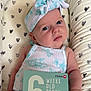 Summer joined the competition — help win amazing prizes! baby, infant, headband, milestone_card, six_weeks_old, floral_pattern, heart_pattern, cushion, close_up, portrait, cute, young_child, lying_down, clothing, person, newborn, skin, expression, indoors, soft_lighting