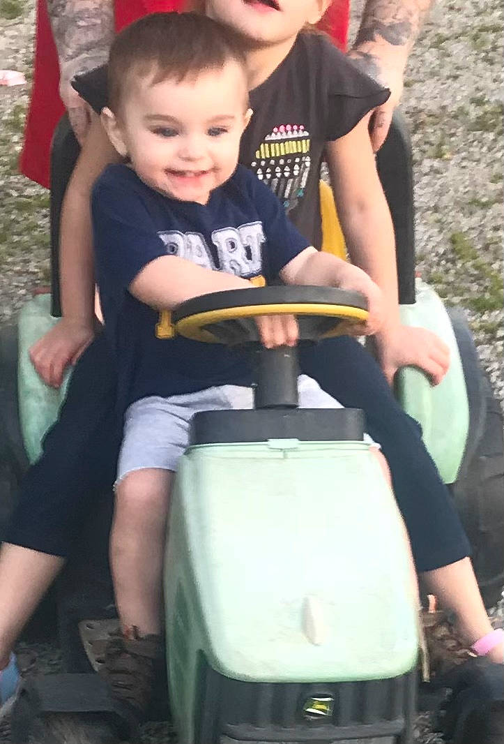 Jay is registered to the contest to win money with this photo: baby, baby_toddler_clothing, fun, grass, green, happy, joy, lap, leisure, person, photograph, recreation, riding_toy, shorts, sitting, smile, snapshot, t_shirt, thigh, tire