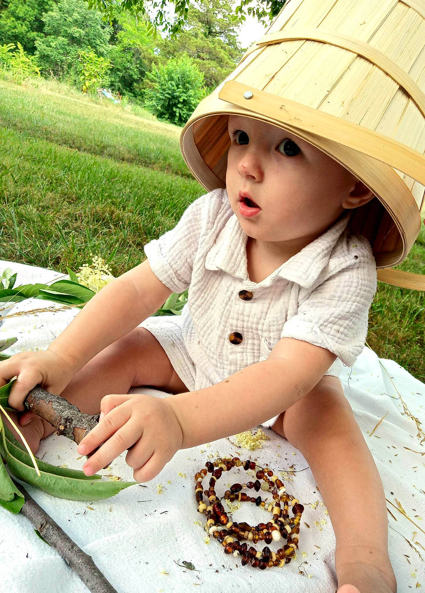 Atlas joined the competition — help win amazing prizes! baby_toddler_clothing, cap, child, comfort_food, fashion_accessory, garden, grass, green, happy, hat, headwear, leaf, pattern, people_in_nature, person, plant, recreation, sitting, soil, sun_hat