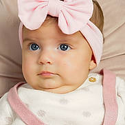 Cassie participe au concours pour gagner de l'argent avec cette photo : baby, child, face, headband, pink_bow, blue_eyes, clothing, knitwear, cute, portrait, infant, closeup, soft_background, adorable, young_child, sitting, indoors, person, fashion, baby_fashion