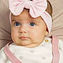 baby, child, face, headband, pink_bow, blue_eyes, clothing, knitwear, cute, portrait, infant, closeup, soft_background, adorable, young_child, sitting, indoors, person, fashion, baby_fashion