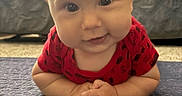 Pierce is registered to the contest to win money with this photo: baby, carpet, child, couch, cute, eyes, face, forearms, happy, head, indoor, infant, living_room, person, pillow, portrait, red_clothing, skin, smile, young