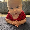 Pierce is registered to the contest to win money with this photo: baby, infant, smile, red_clothing, face, forearms, indoor, carpet, couch, pillow, living_room, cute, child, portrait, young, happy, skin, head, eyes, person