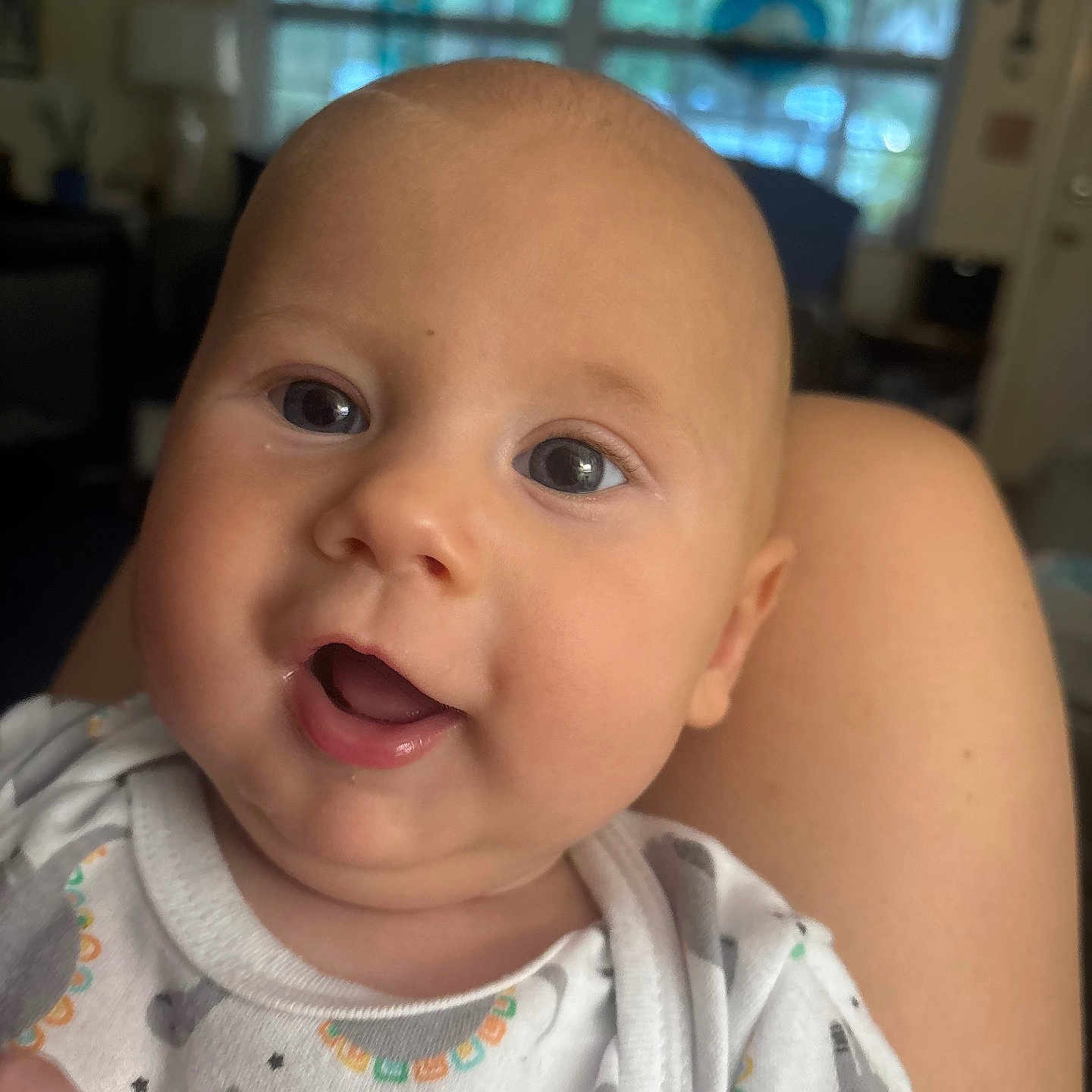 Pierce is registered to the contest to win money with this photo: baby, infant, smiling, face, portrait, clothing, onesie, dinosaur_pattern, cute, child, indoor, person, happy, skin, head, eyes, mouth, expression, baby_garment, closeup