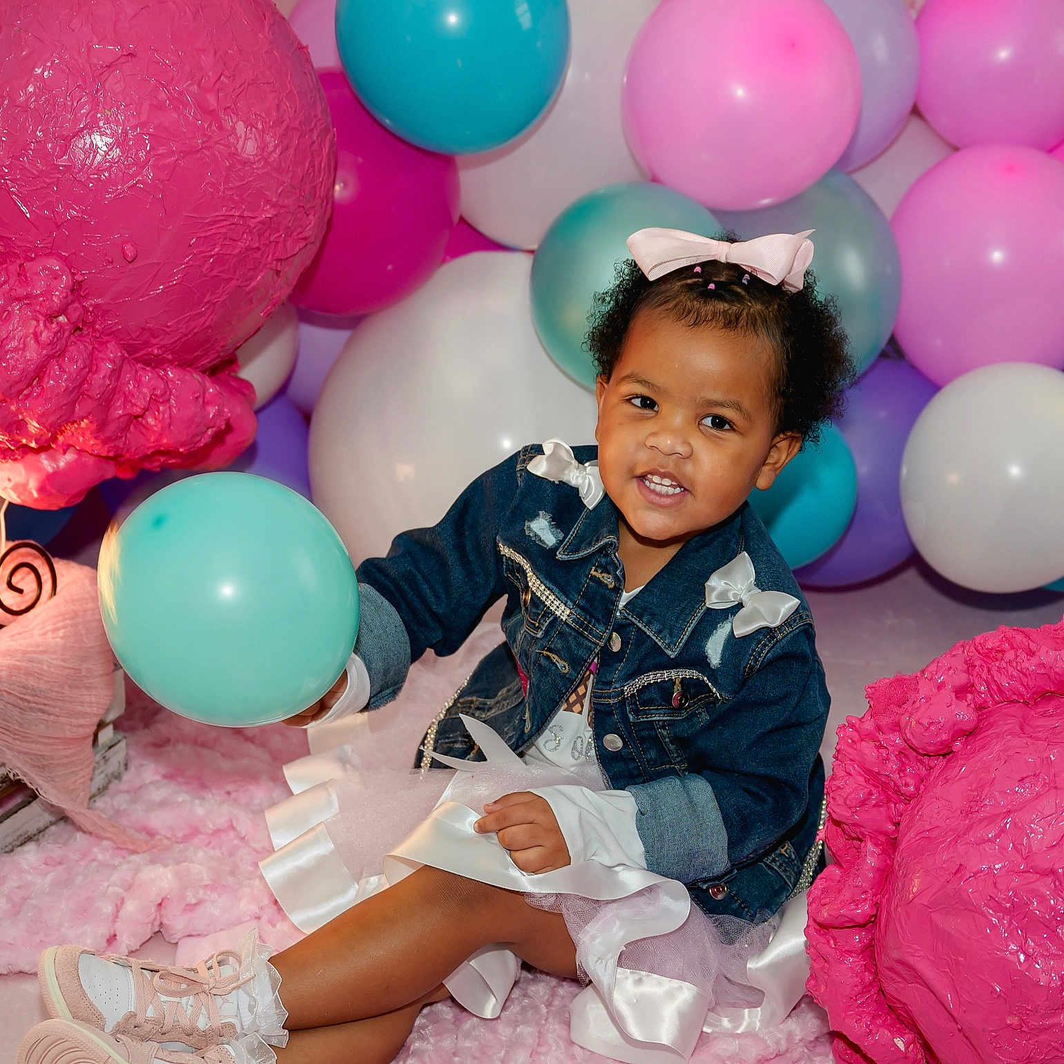 Karter joined the competition — help win amazing prizes! balloon, celebration, child, colorful_balloons, cute, denim_jacket, dress, festive, fun, happy, indoor, party_decorations, person, pink_bow, pink_rug, playful, smiling, sneakers, texture, toddler