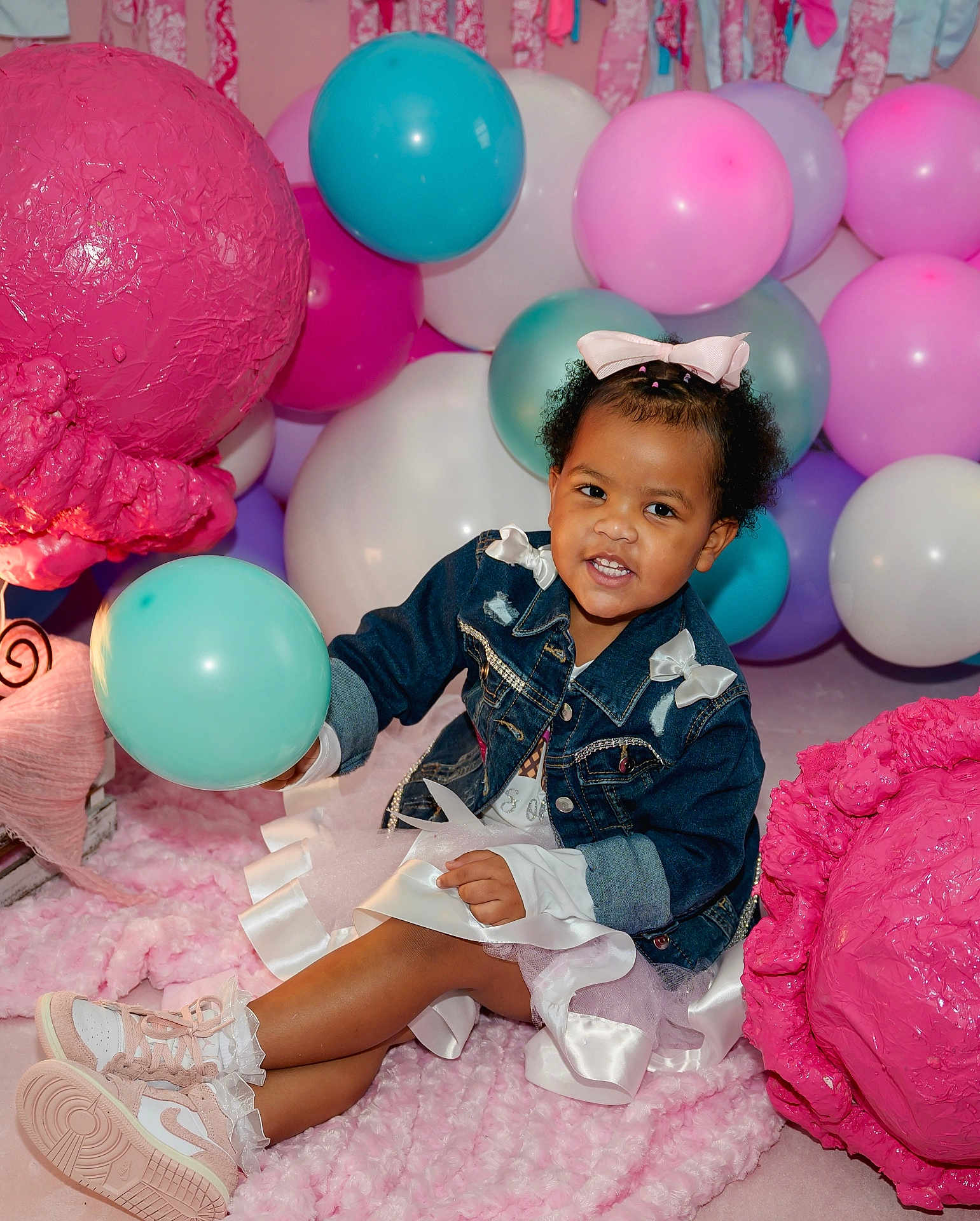 Karter joined the competition — help win amazing prizes! child, toddler, denim_jacket, dress, balloon, pink_bow, sneakers, pink_rug, party_decorations, colorful_balloons, smiling, indoor, cute, celebration, festive, happy, person, texture, playful, fun