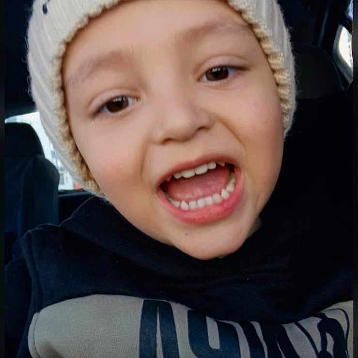 Mateo joined the competition — help win amazing prizes! child, smiling, portrait, close_up, car, indoors, winter_hat, scarf, warm_clothing, black_clothing, toothy_grin, open_mouth, brown_eyes, light_skin, seated, vehicle_interior, selfie, happy, casual, photograph
