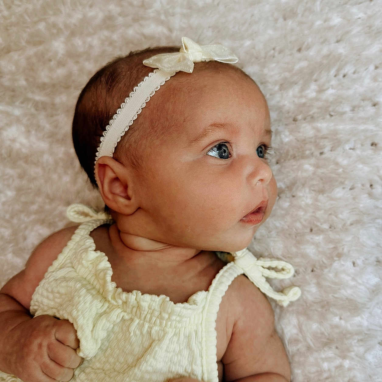 Elliemae is registered to the contest to win money with this photo: accessories, baby, bodypart, bonnet, clothing, dress, face, finger, hand, happy, hat, head, headband, jewelry, newborn, person, photography, portrait, sitting, smile